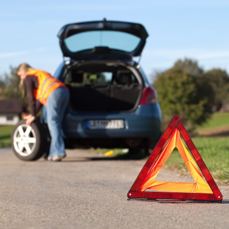 Broken down car with a red warning triangleの写真素材