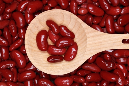 Group of kidney beans on a wooden spoon forming a backgroundの写真素材