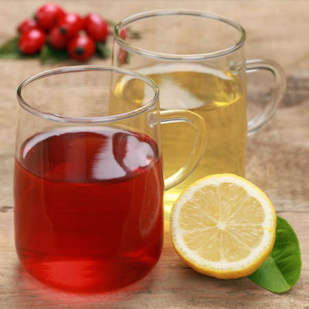 Red and yellow tea in glasses on a wooden tableの写真素材