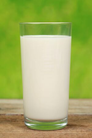 Fresh milk in glass on a wooden tableの写真素材