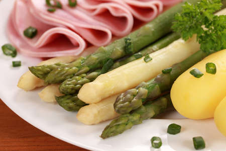 Cooked Asparagus served with ham and potatoesの写真素材