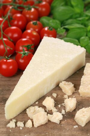 Parmesan cheese decorated with tomatoes and basilの写真素材