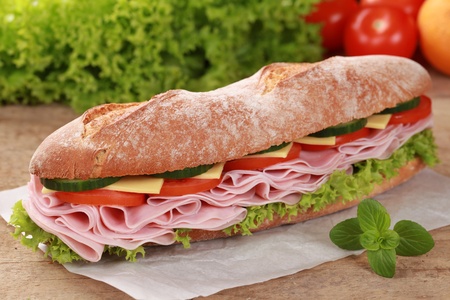 Baguette with ham, cheese, tomatoes, lettuce and cucumberの写真素材