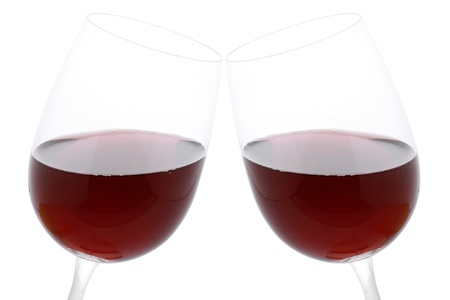 Clink glasses with red wine, isolated on a white backgroundの写真素材