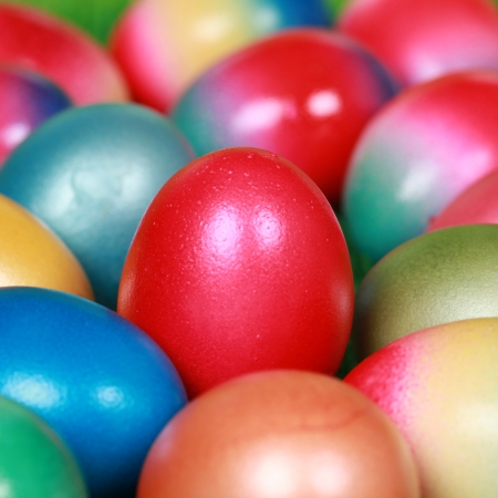 Collection of colorfully painted Easter eggs forming a backgroundの写真素材