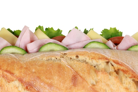 Top view of a baguette with ham, cheese, tomatoes, lettuce and cucumberの写真素材