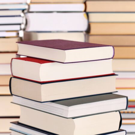 Books in a stack, with more books forming a backgroundの写真素材