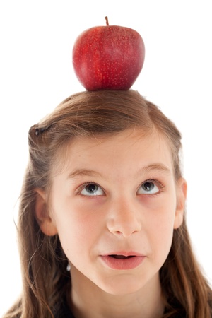 A young girl having an apple on her headの写真素材