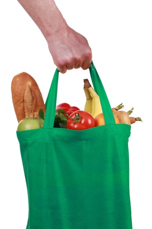 Hand holding a bag filled with groceries, isolated on whiteの写真素材