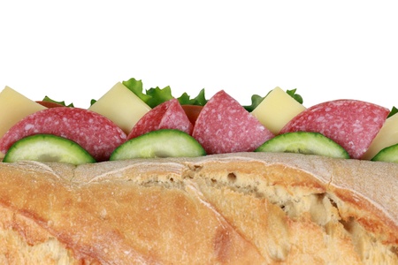 Top view of a baguette with salami, cheese, tomatoes, lettuce and cucumberの写真素材