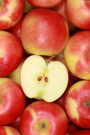 Red apples background with a sliced appleの写真素材