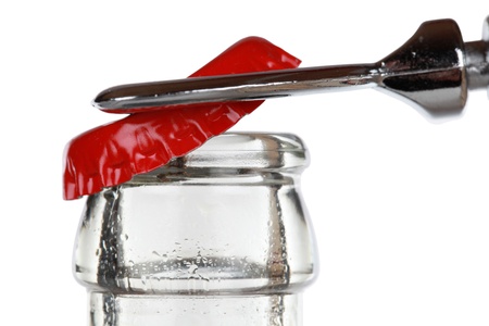 Opening a cola bottle with an opener, isolated on white background