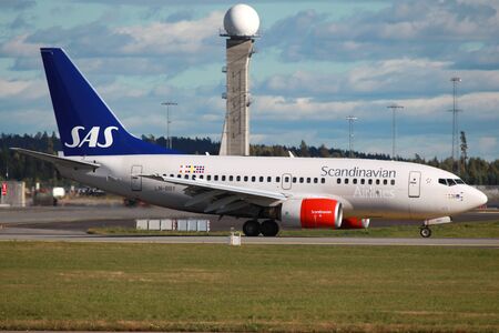Oslo, Norway - September 15, 2012: A SAS Scandinavian Airlines Boeing 737-600 with the registration LN-RRY taxis at Oslo Airport (OSL) in Norway. SAS is the largest airline in Scandinavia and headquartered in Stockholm. SAS operates with 152 aircraft. In のeditorial素材