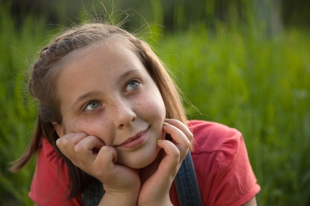 Portrait of a young girl day dreaming in natureの写真素材