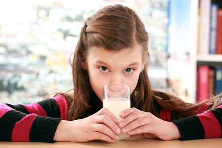 Concept healthy eating with a girl drinking milk from a glassの写真素材