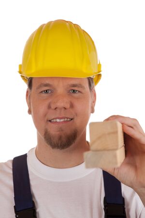 Construction worker with safety helmet holding wooden slats in his hand, isolated on whiteの写真素材