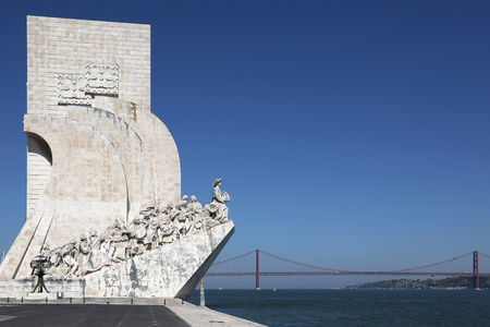 Monument for the discoverers with a suspension bridge in Belem in Lisbon Portugalのeditorial素材