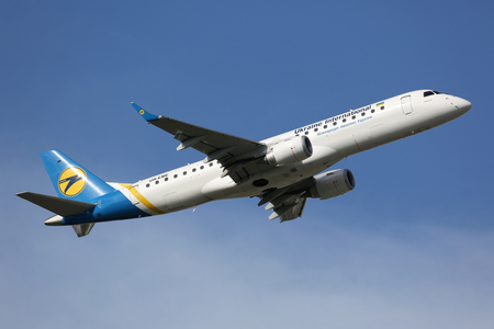 Munich, Germany - October 26, 2013: A Ukraine International Embraer ERJ-190 with the registration UR-EME takes off from Munich Airport (MUC) in Germany. Ukraine International is the flag carrier airline of the Ukraine. It operates with 40 aircraft.のeditorial素材