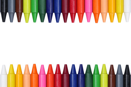 Crayons for children forming a frame, isolated on a white backgroundの写真素材