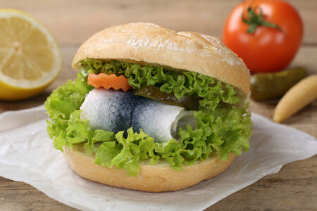 A sandwich with herring served with a tomatoの写真素材