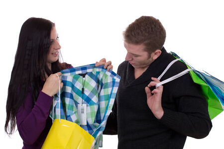 Young couple with shopping bags buying clothes, isolated on a white background
