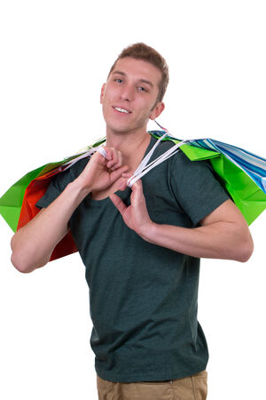 Smiling young man with shopping bags, isolated on a white backgroundの写真素材