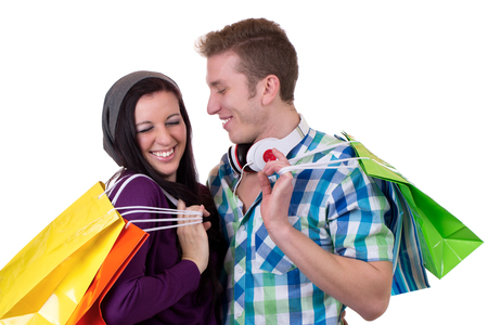 A young couple having fun while shopping, isolated on a white backgroundの写真素材