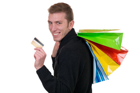 Smiling man with credit card and shopping bags, isolated on a white backgroundの写真素材