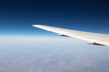 Airplane wing while traveling during a flightの写真素材