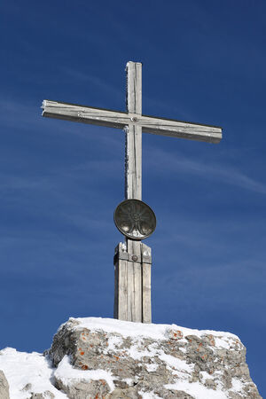 Cross on the summit of a mountain in the Alpsの写真素材