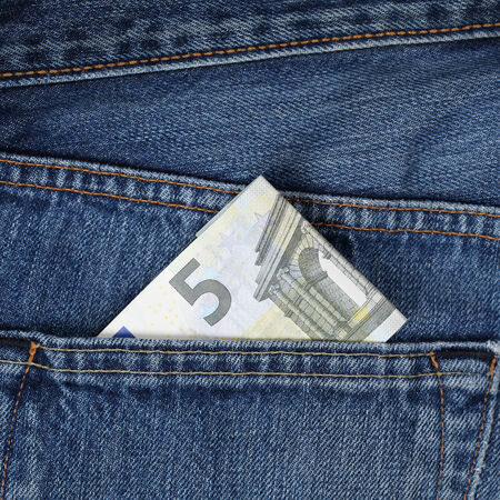 A 5 Euro money banknote in a trouser pocket, pickpocket topicの写真素材