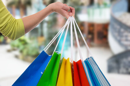 Young woman holding shopping bags in her hand in a shopping mallの写真素材
