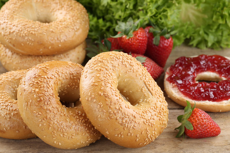 Breakfast with fresh bagels, marmalade and strawberriesの写真素材