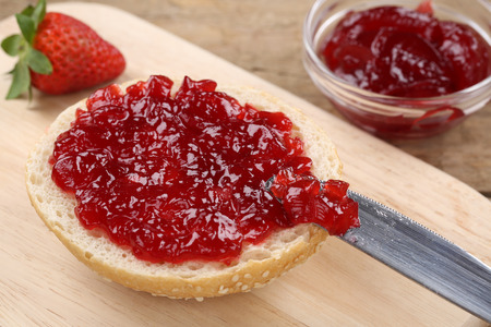 Healthy breakfast with strawberry marmalade on a rollの写真素材