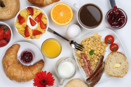 Breakfast with a cereals, bagels, scrambled eggs, marmalade, coffee and orange juice from aboveの写真素材