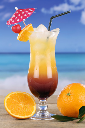 Tequila Sunrise cocktail drink on the beach at the seaの写真素材