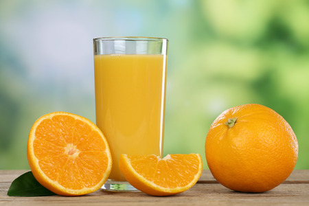 Orange juice and fresh oranges fruits in summerの写真素材