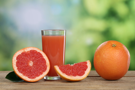 Grapefruit juice and fresh grapefruits fruits in summerの写真素材