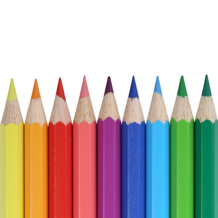 School supplies colored pencils in a row with copyspace, isolated on a white backgroundの写真素材