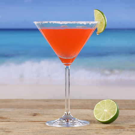 Red cocktail Martini drink on the beachの写真素材