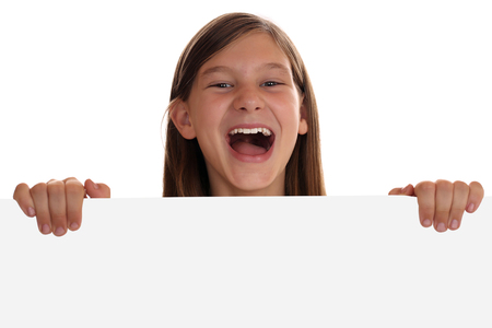 Young girl having fun with an empty sign with copyspace, isolated on a white backgroundの写真素材