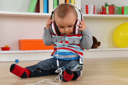 Portrait of a baby listening to music with headphonesの写真素材