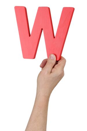 Hand holding letter W from alphabet isolated on a white backgroundの写真素材