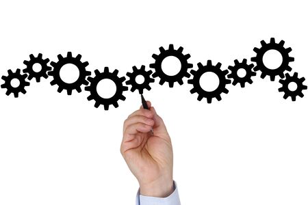 Businessman writing business plan for success, team, growth and moving gear wheelsの写真素材