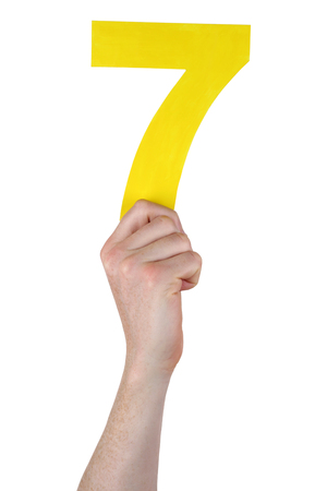 Hand holding number 7 isolated on a white backgroundの写真素材