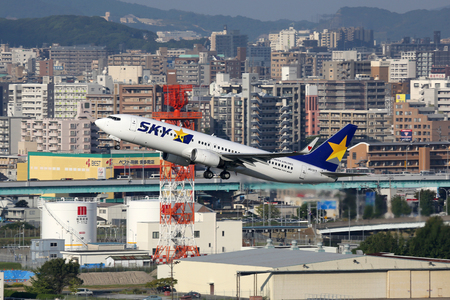 Fukuoka, Japan - October 13, 2015: A Skymark Airlines Boeing 737-800 with the registration JA737T takes off from Fukuoka Airport (FUK) in Japan. Skymark Airlines is a low-cost airline from Japan with its headquarters in Tokyo.のeditorial素材