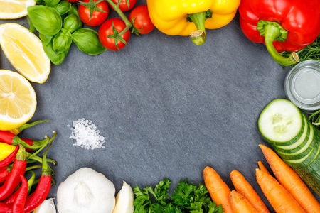 Vegetables collection tomatoes carrots cooking ingredients slate bell pepper background top view from aboveの写真素材