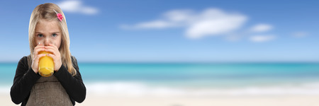 Child girl kid drinking orange juice banner copyspace summer healthy eating copy spaceの写真素材