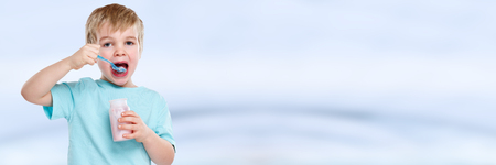 Child kid boy eating yogurt healthy copyspace copy space bannerの写真素材