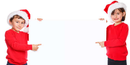 Children kids boy girl Christmas Santa Claus pointing empty banner copyspace copy spaceの写真素材